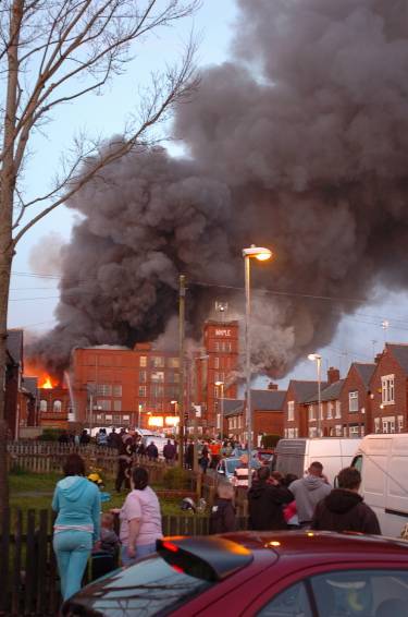 LOCAL residents gather to watch as the fire takes hold 
