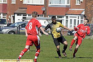 CLOSING IN: Red Star’s Paul Burns moves in to challenge as Coppice’s Waqar Younif tries to bring the ball under control (left.)