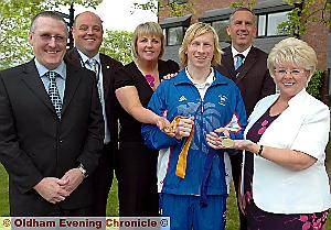 GYMNAST Craig Heap shows off his medals with (from left) Paul Clark (Counthill School Sports Partnership); Neil Consterdine (Oldham Council’s head of integrated youth) Lorna Philip; Dave NcEntee (Hathershaw assistant deputy head teacher); and Councillor Kay Knox (cabinet member for children, young people and families).
GYMNAST Craig Heap shows off his medals with (from left) Paul Clark (Counthill School Sports Partnership); Neil Consterdine (Oldham Council’s head of integrated youth) Lorna Philip; Dave NcEntee (Hathershaw assistant deputy head teacher); and Councillor Kay Knox (cabinet member for children, young people and families).