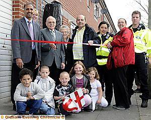 UNITED . . . the office is opened by Denis Lofthouse, who has lived on the estate since 1950, cutting the ribbon with Councillor Mohammed Masud to his left and chairman David Wilkinson to his right 
