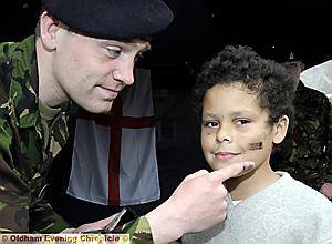 DAVID Hewitt, from the Royton detachment, Our Lady’s Cadets, puts camouflage paint on Dale Rees’s (7) face 