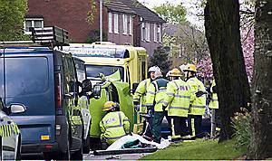Chronicle reader Dave Brandwood captures the drama as fire-fighters work to cut the woman free from her car and get her into the ambulance 