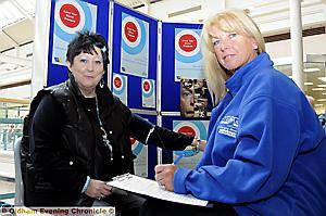 Maria Hart (left) is pictured getting her blood pressure checked by Julie Jones, family and carer support co-ordinator. 
