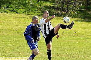 THAT’S MINE: Anthony Healey, of Halfway House, clears from Adam Darlington of Springbank. 