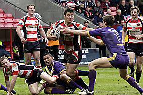 HAND OFF: Oldham’s Dave Allen pushes away Ben McAlpine’s attempted tackle as he makes a break for the line.
