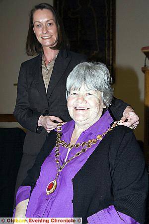 OUTGOING Shaw and Crompton Parish Council chairman Hazel Gloster, left, presents the chains to new chairman Councillor Mari Wiswell 