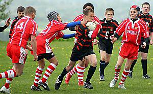 ON THE CHARGE: Billy McDermott, of Oldham Service Area under-12s, attempts to break through the Wigan and Leigh line. ON THE CHARGE: Billy McDermott, of Oldham Service Area under-12s, attempts to break through the Wigan and Leigh line.