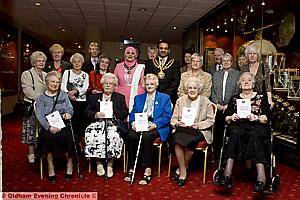 THE Women’s Land Army and Timber Corp Badge recipients with (centre) Mayor of Oldham, Councillor Shoab Akhtar and Mayoress Shafeena Kausar 