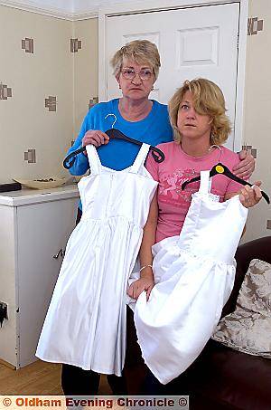 EMBARRASSED . . . Andrea and her mum Kathleen with two of the dresses EMBARRASSED . . . Andrea and her mum Kathleen with two of the dresses