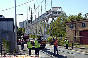 A precision operation saw the bridge lowered on to a lorry in preparation for for its cross-border journey A precision operation saw the bridge lowered on to a lorry in preparation for for its cross-border journey
