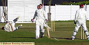DOWN AND OUT: Werneth’s Andy Walker (grounded) is run out.