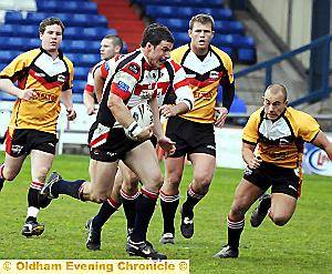 CATCH ME IF YOU CAN: Oldham prop Richard Mervill charges through the Hunslet line.