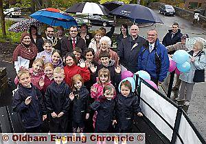 CELEBRATION . . . residents at the opening of Diggle Tunnel Tip with Oldham Mayor Councillor Shoab Akhtar, Mayoress Shafeena Kausar, Phil Woolas MP, Rev Duncan Rhodes of Kiln Green Church, Margaret Cobbold of Veolia Environmental Trust, Carol Seddon of the Environment Agency, and Stewart Laming of Parks and Countryside Development 