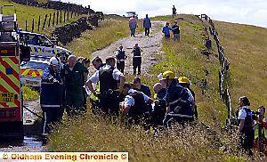 Emergency crews surround David Cummaford and (inset), the injured pilot is stretchered away 