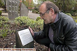 Tony Smith, secretary of the Joint Trades’ Unions and the former local Unison chairman, reads the workers’ memorial plaque 
