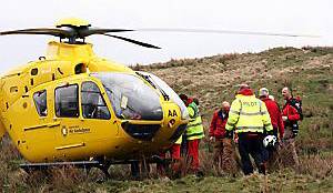 AIR alert . . . medics prepare to air-lift the injured man to hospital 
