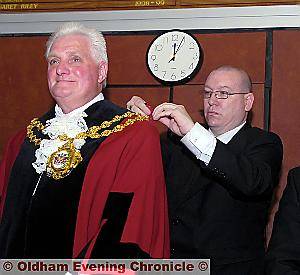PROUD moment . . . Councillor Jim McArdle receives his chain of office from attendant Dean Hay PROUD moment . . . Councillor Jim McArdle receives his chain of office from attendant Dean Hay