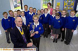 WORTHY winners . . . Philip Hibbert, vice-president of the Rotary Club of Oldham Metro, presents the trophy to Elicia Rawsthorne, watched by fellow St Hugh’s pupils who took part and teacher Karen Barton WORTHY winners . . . Philip Hibbert, vice-president of the Rotary Club of Oldham Metro, presents the trophy to Elicia Rawsthorne, watched by fellow St Hugh’s pupils who took part and teacher Karen Barton