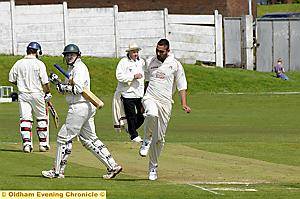 Crompton bowler Aquib Zulfiquar celebrates as Royton’s Dave Clarke walks. 