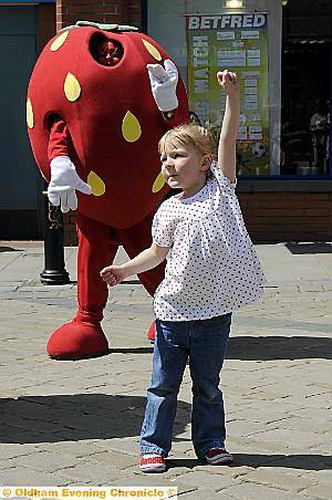PROMOTING healthy eating . . . Courtney Newton dances along with the 5-a-day strawberry 