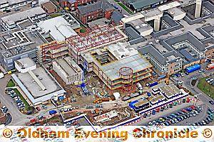 The main body of the development is in the centre of the aerial photograph. Its main entrance will be through the circular structure.
The bunker which will house the linear accelerators is on the left. On the far left is the existing hospital sterilisation and disinfection unit.
The space at the front of the bunker will have car parking spaces for people having radiotherapy, and the cars at the front left of the photograph are on the site of a planned multi-storey car park.