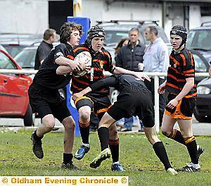 Oldham under-15s Oliver Kerr takes on the Lancashire defence 
