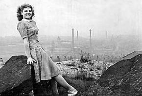 MILLS and boon . . . Joyce high up on the hills of Waterhead with Oldham's industrial life teeming in the background 