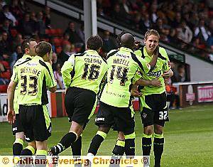 WELL DONE LAD! Ryan brooke gets a hug for his efforts from Sean Gregan and Reuben Hazell. 