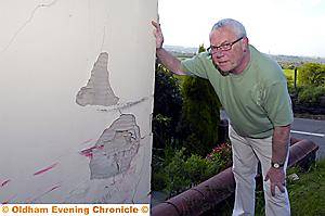 CRUNCH . . . Alan Sweeting shows the damge to his house from the latest accident 