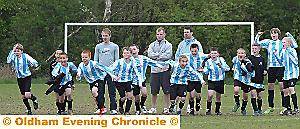 THE Champions League final it isn’t. But the joy of winning a penalty shoot-out to clinch a trophy is just the same - be it Manchester United or Crompton House School. The coaches may seem laid back, but for the youngsters there is no hiding the delight after Crompton House won the Year 7 Oldham Schools final 5-3 on spot-kicks against Failsworth, at the Lancaster Club. Picture: VINCENT BROWN. 