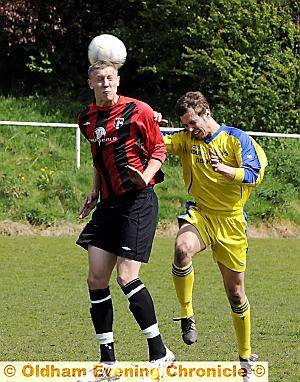 HEADS I WIN: Springhead’s Richard Bennett beats Leigh Athletic’s Danny Mellin to the ball.