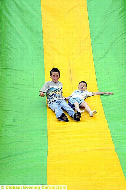 Whoosh! Ross Halam (10) and Joe Wolfenden (7) on the carnival slide.
To buy this picture, call us on 0161 622 2130