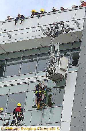 DON’T look down . . . mountain rescue officer Mick Nield brings the worker to safety