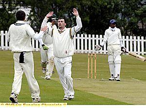 STRIKE ONE: Moorside bowler Lee Warburton revels in the wicket of Austerlands opener Abhi Ettimadai.