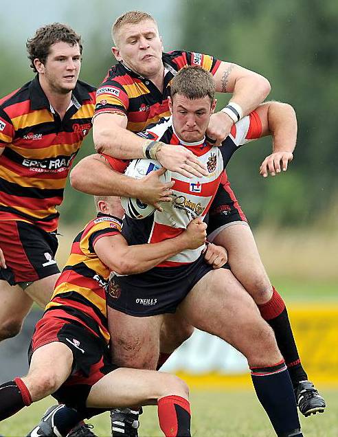 NO YOU DON’T . . . Oldham’s Luke Sutton’s progress is halted by two Dewsbury tacklers. 