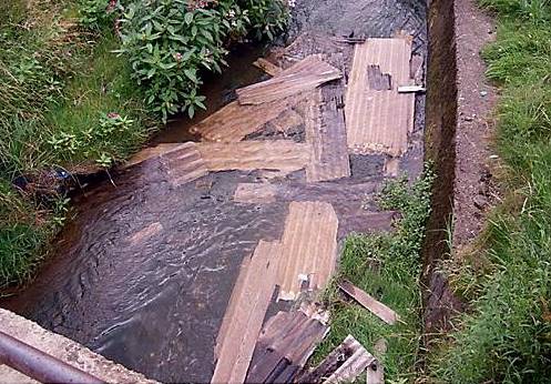 Sheets of asbestos dumped in the River Medlock 
