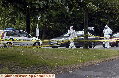 Forensics officers in the lane yesterday.

