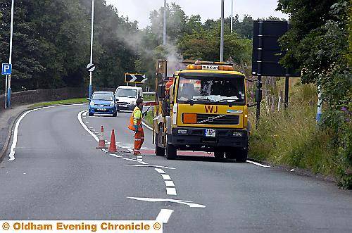 Caption: WHITE lines ... new road markings are painted on to the A62 Oldham Road in Delph Caption: WHITE lines ... new road markings are painted on to the A62 Oldham Road in Delph