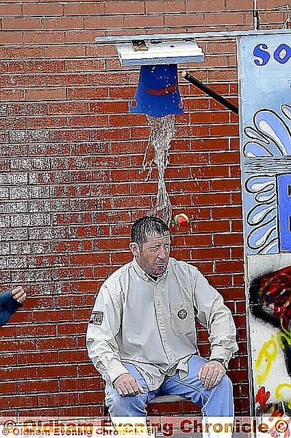 Good sport Phil Howarth, of the 12th Oldham Scouts, gets a dousing. 