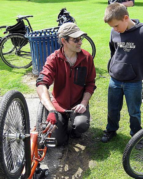ROLLING repairs . . . a young cyclist gets his bike fixed 