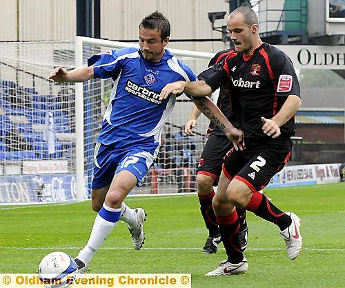 SHADOWING ROLE: Keigan Parker holds off Carlisle United full-back David Raven. 