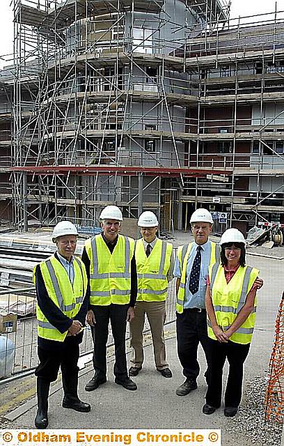 RISING star . . . the new cancer centre with David Makin, Christie governor, Rev Phil Sumners, from the Interfaith Forum, Phil Turner, project manager at Christie, Dave Davies, site manager, and Tracy Cropper, of Oldham Council’s people, communities and society section 