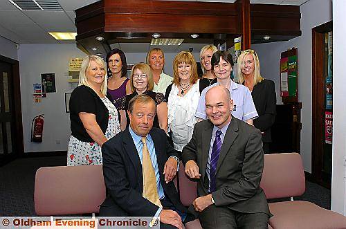 Doctors Ian Whitley (left) and John Kelso pictured with surgery staff Doctors Ian Whitley (left) and John Kelso pictured with surgery staff