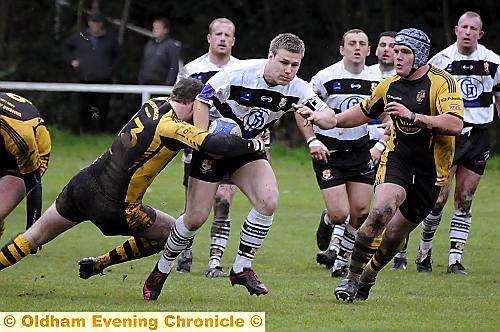 coming through . . . Shaun Robinson, of Saddleworth Rangers, attempts to punch a hole in the Leigh Miners line. 