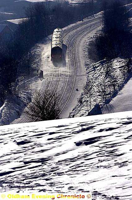 THE train takes the strain through Mossley on the main line through Saddleworth to Manchester 