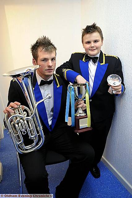 Best of brass . . . Uppermill band member Ben Pollard celebrates a four-in-a-row win with Richard Blythe at their last contest of the year Best of brass . . . Uppermill band member Ben Pollard celebrates a four-in-a-row win with Richard Blythe at their last contest of the year