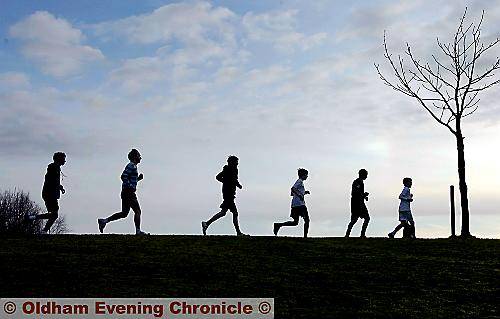 SILHOUETTED against the skyline in Tandle Hill Park, members of the Oldham town-team cross-country squad in training. Pictures by ANTHONY MILLER. 