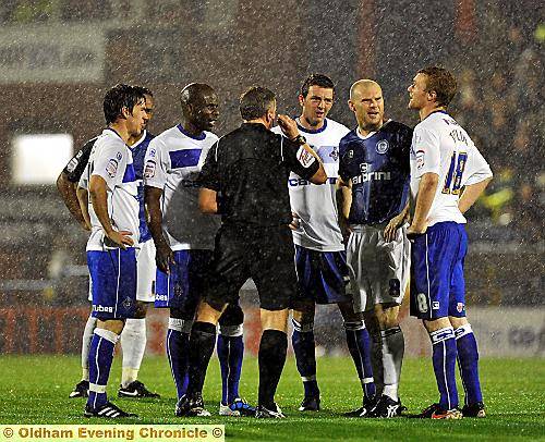 Referee in discussion with players  