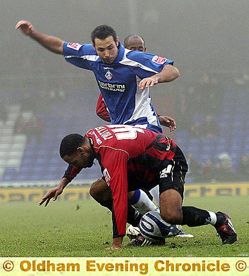 ATHLETIC striker Pawell Abbott and Millwall’s Liam Trotter tussle for the ball. 