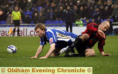 GROUNDED: Athletic forward Chris Taylor and Millwall’s Jack Smith get in a tangle. 
